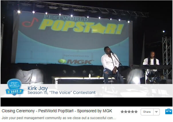 Screenshot of closing ceremony; Kirk Jay singing on stage with piano accompaniment, and backdrop with PestWorld Popstar logo and MGK logo 