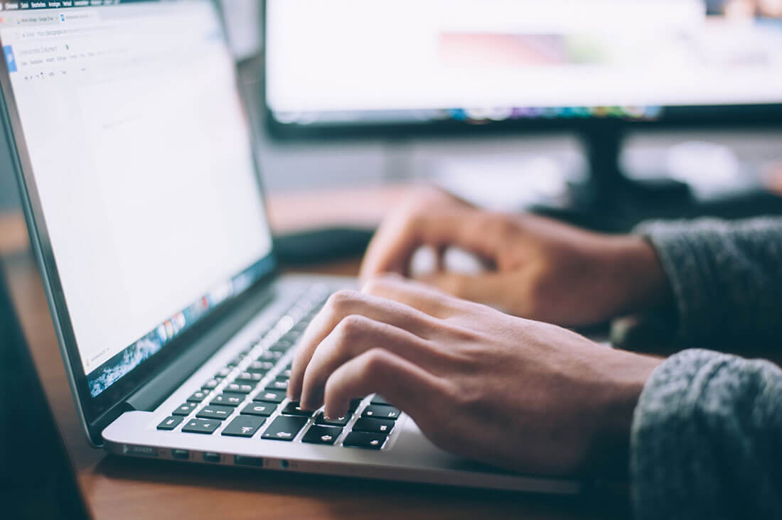 Hands typing on laptop, Photo by Glenn Carstens-Peters on Unsplash